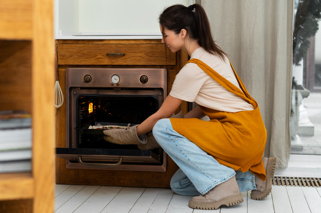 Woman cooking pizza in kitchen